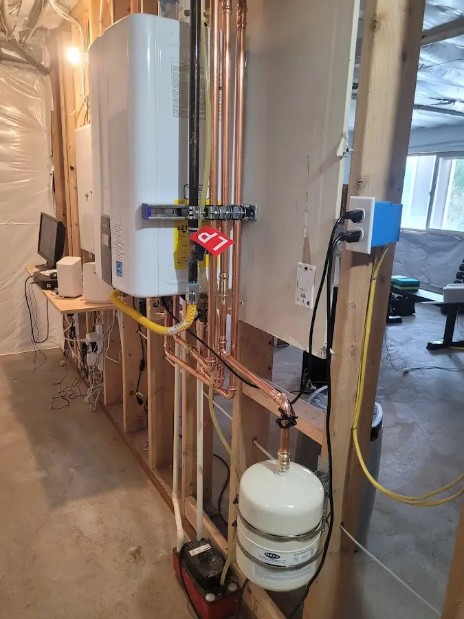 Licensed plumber repairing a kitchen sink in Bennington